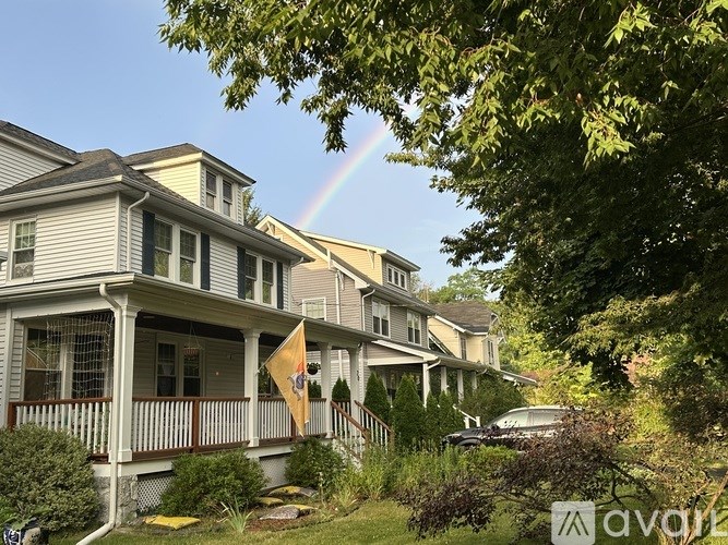 A house with a rainbow in the sky.