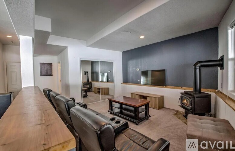 A modern living room with a wood floor and a wood table.