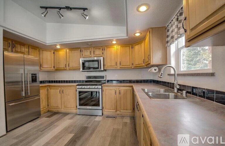 A kitchen with wooden cabinets and stainless steel appliances.