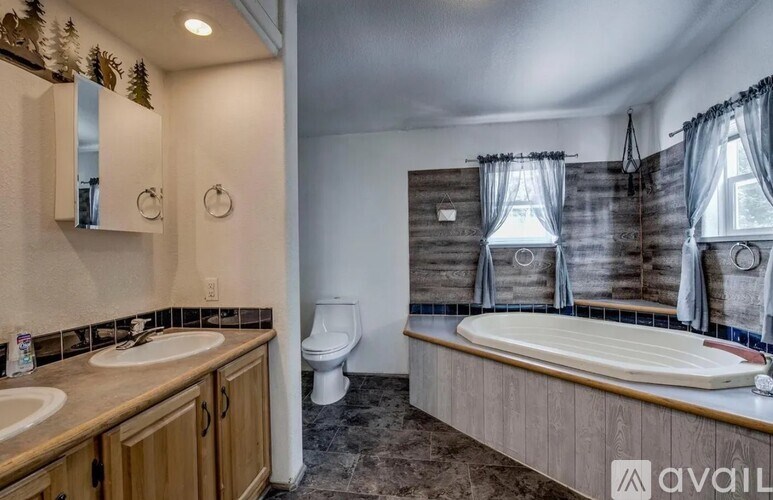 A bathroom with a wooden vanity and a bathtub.