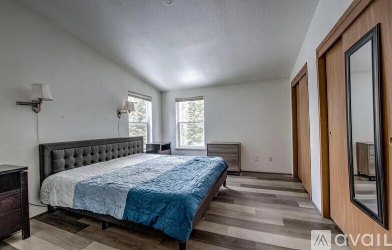 A bedroom with a large bed and a window.