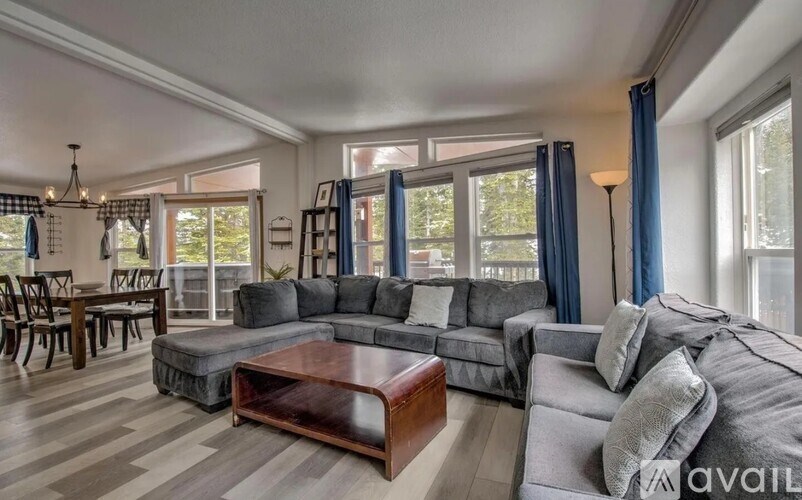 A living room with a grey couch and a coffee table.