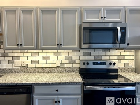 A kitchen with a stove top oven and a microwave above it.