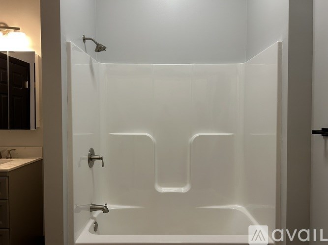 A shower with a glass door and a wall-mounted shower head.