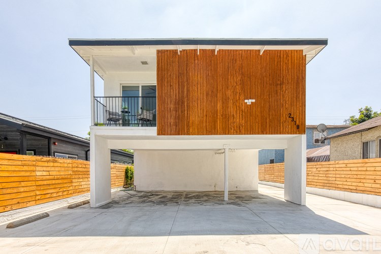 A modern house with a white and wood exterior.