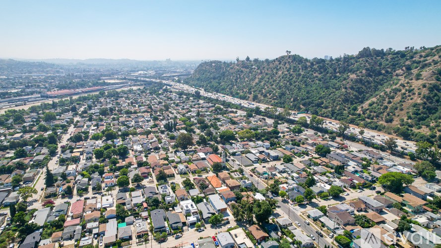 A bird's eye view of a residential area with houses and streets.
