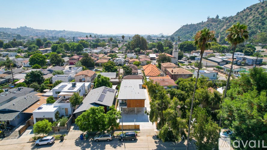 A bird's eye view of a residential area with houses and cars.
