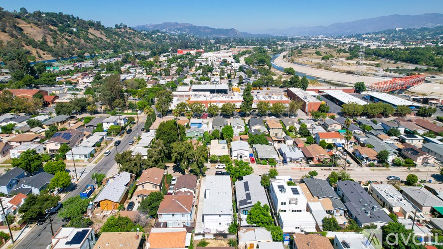 A bird's eye view of a residential area with houses and a river.