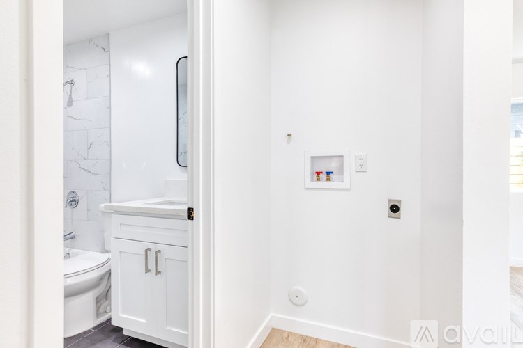 A white bathroom with a toilet, sink, and medicine cabinet.