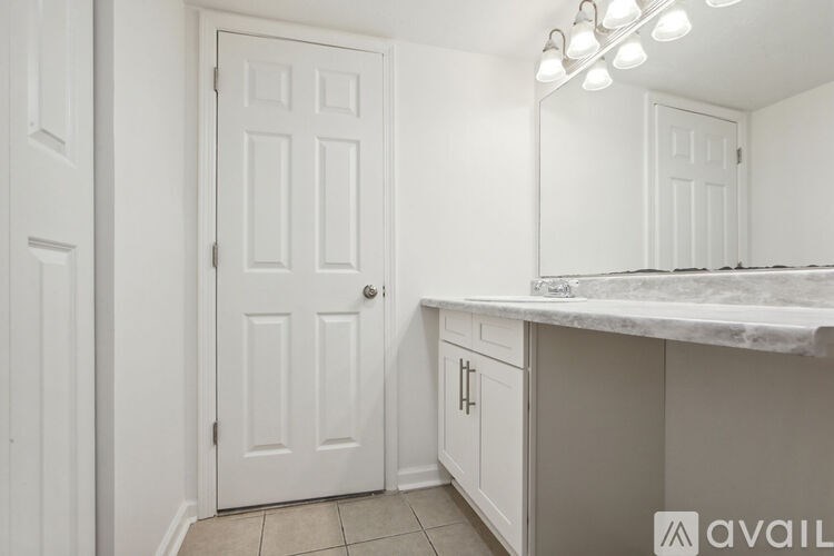 A white door is in a room with a counter top.