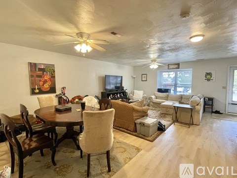 A living room with a dining table and chairs.