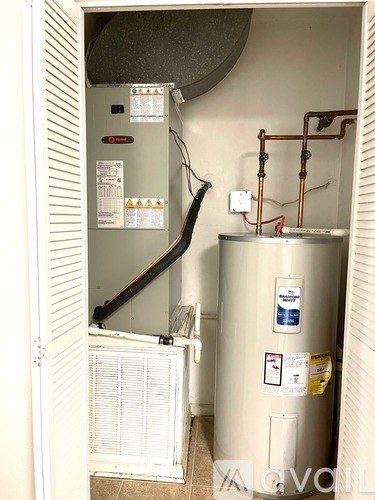 Two white washing machines are sitting next to each other.