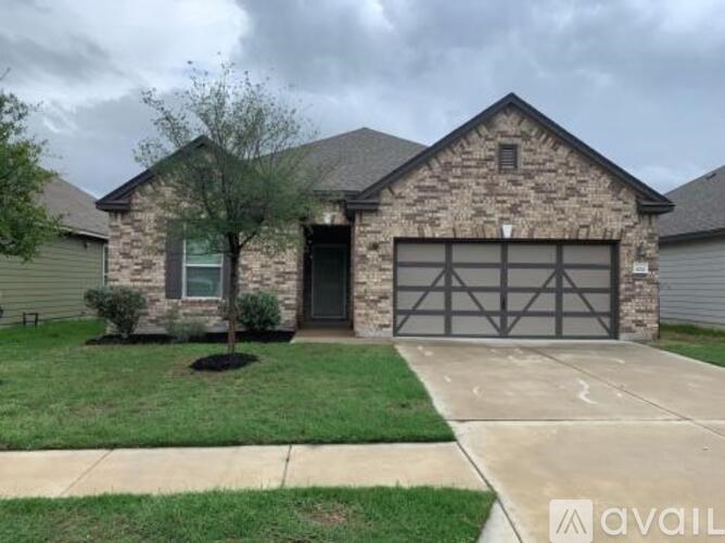 A house with a stone facade and a black garage door.