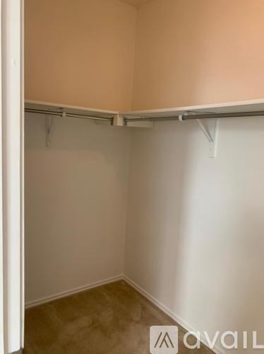 A small, empty room with a carpeted floor and white walls.