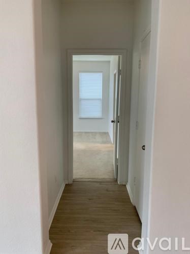 A long hallway with a door at the end.