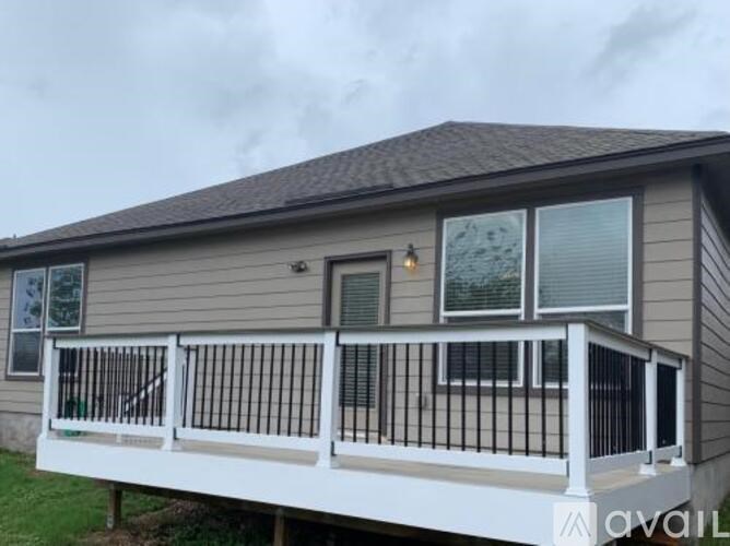 A house with a grey roof and a white balcony.