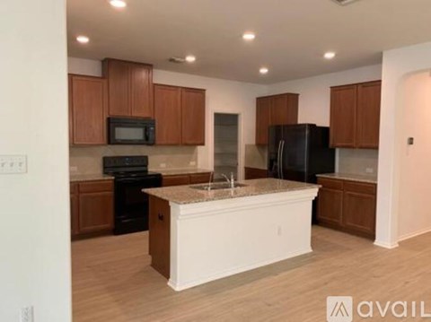 A kitchen with brown cabinets and a white island.