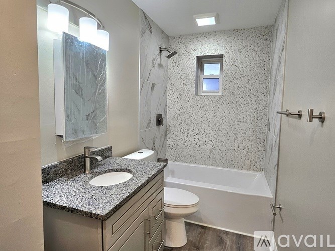 A bathroom with a marble countertop and a white toilet.