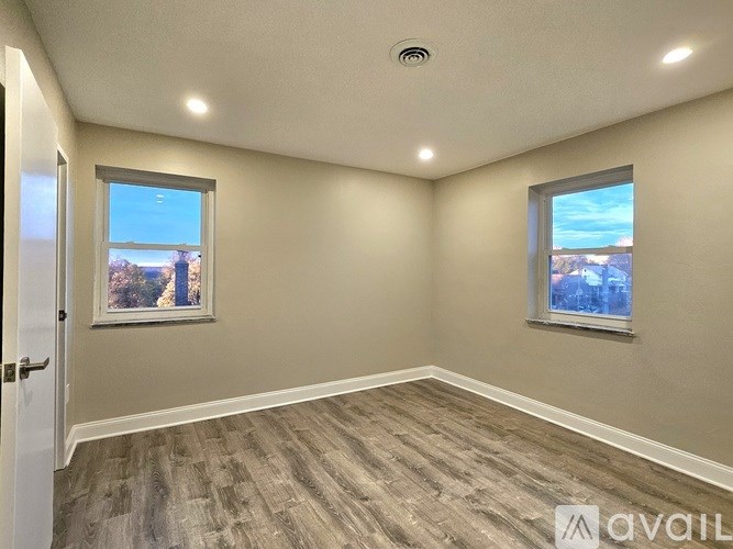 A room with a window and a door is available for rent.