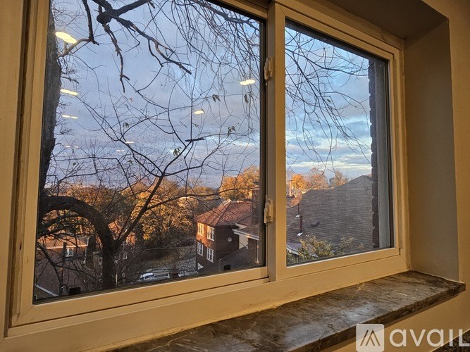 A window with a view of a residential area.