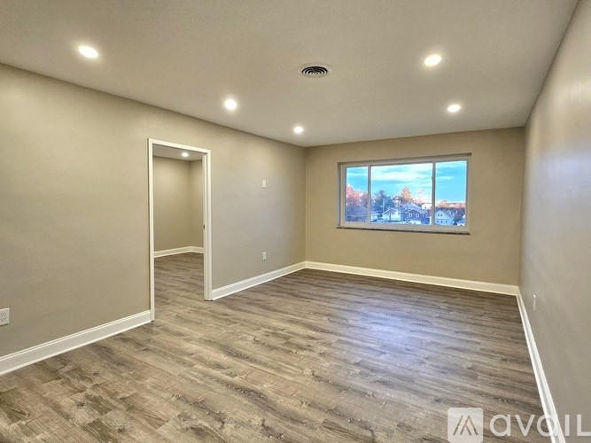 A room with a window and a door.