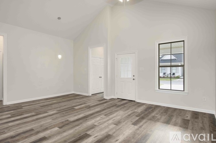 A room with a window and a door is available for rent.