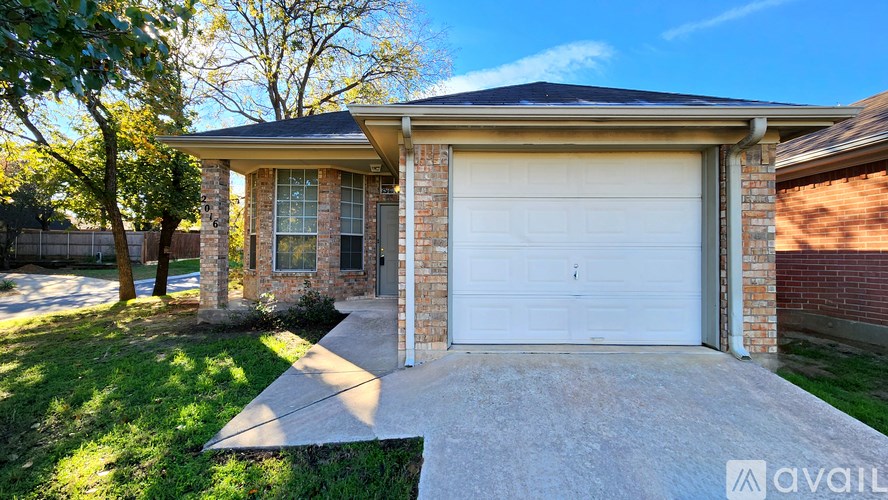 A house with a white garage door is for sale.
