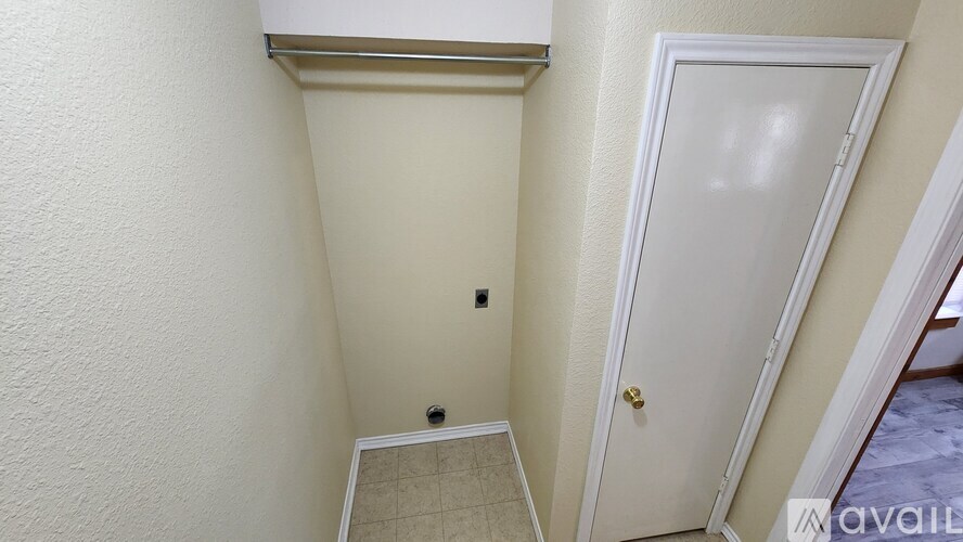 A white door is in a room with white walls.