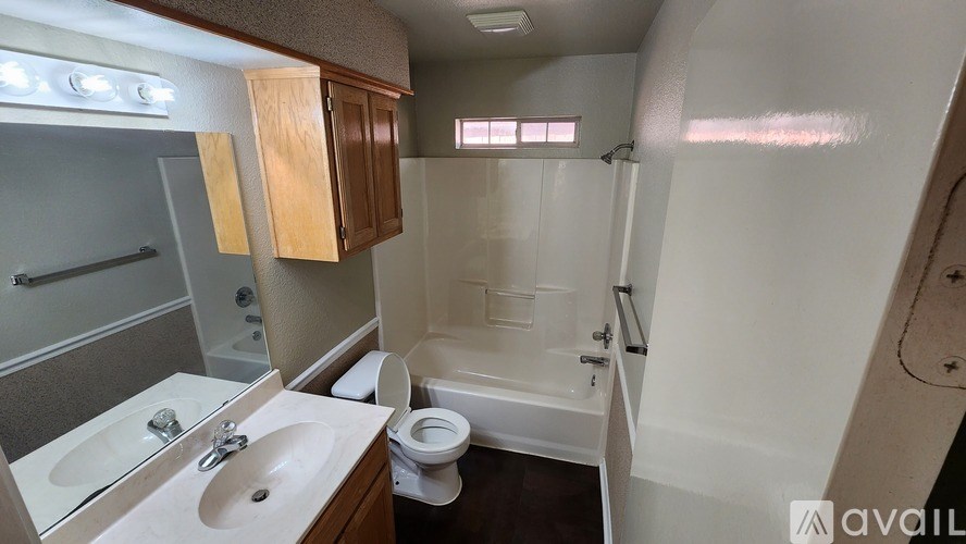 A bathroom with a toilet, sink, and bathtub.