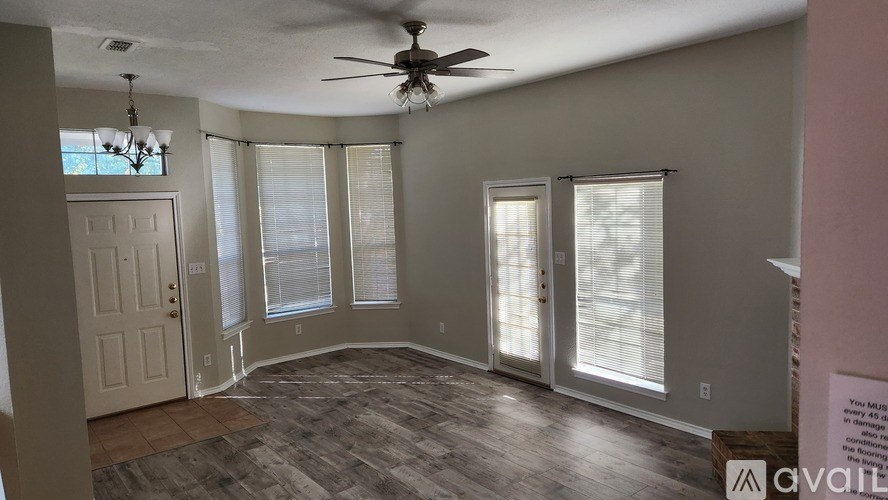 A room with a ceiling fan and a sign that says "available".