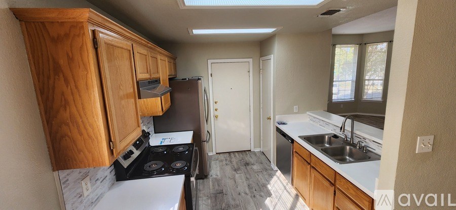 A room with a ceiling fan and a window with blinds.