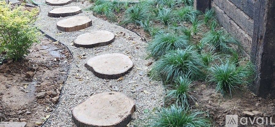 A room with a carpeted floor, a window, and a door leading to another room.