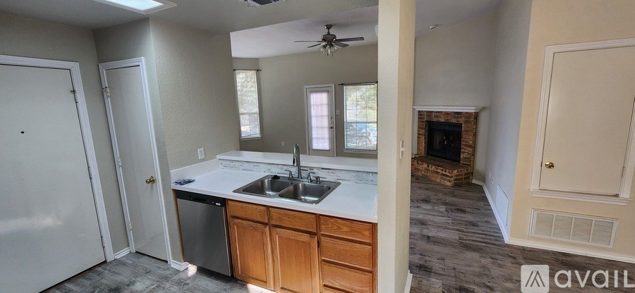 A room with a carpeted floor and a window with blinds.
