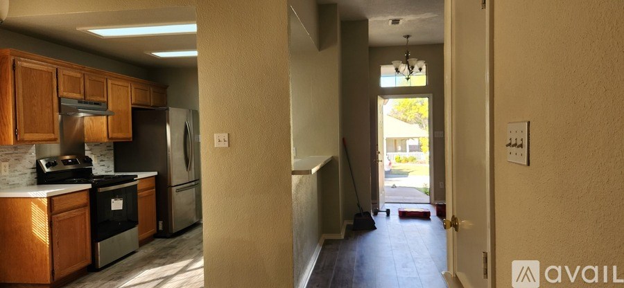 A kitchen with wooden cabinets and a refrigerator.