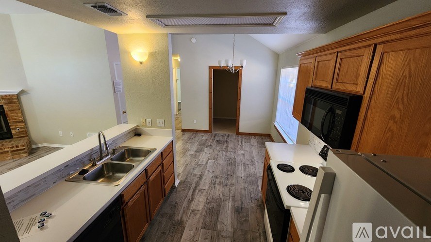 A kitchen with wooden cabinets and a stainless steel oven.