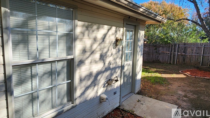 A house with a white door and a window covered with blinds.
