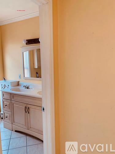 A bathroom with a sink and a mirror.