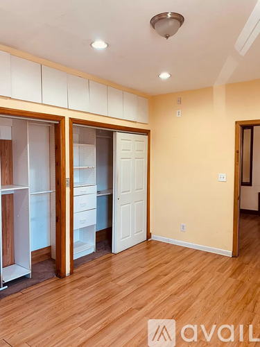 A room with wooden floors and a white door.