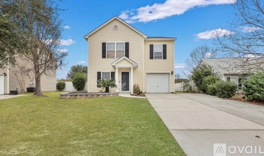 A two-story house with a garage is for sale.