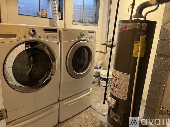 Two front loading washing machines in a laundry room.