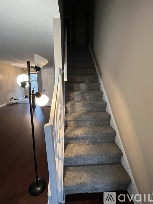 A staircase with a light on the left side.