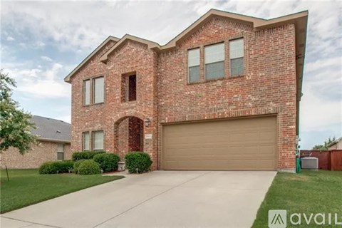 A brick house with a garage door and a driveway.