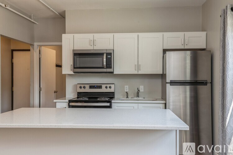 A kitchen with white cabinets and appliances.