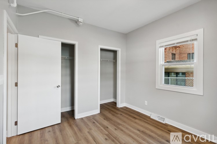 A room with a window and two doors.