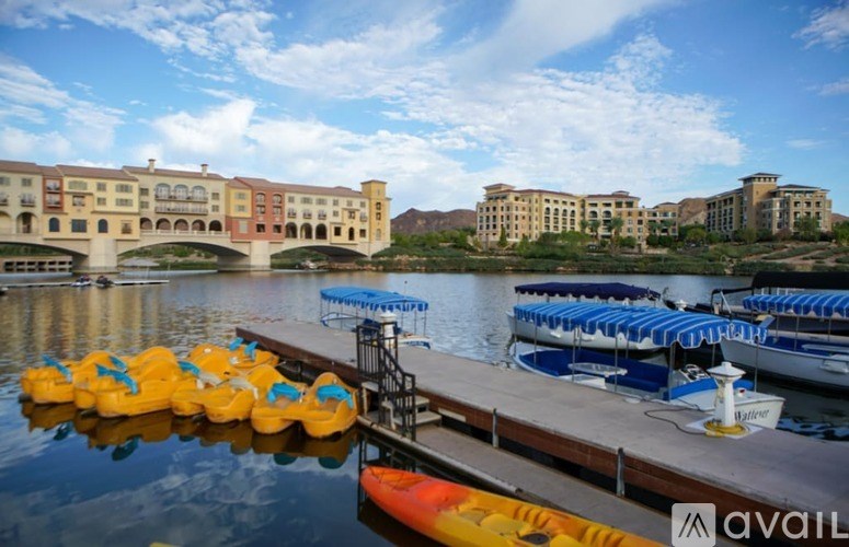 A row of yellow ducky boats are docked at a pier.
