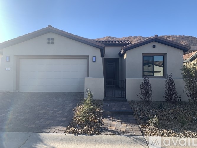 A house with a garage door and a driveway.