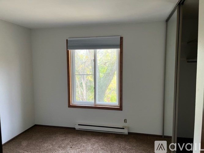 A room with a window and a radiator on the floor.