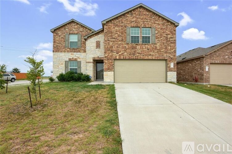 A two-story house with a garage is available for sale.