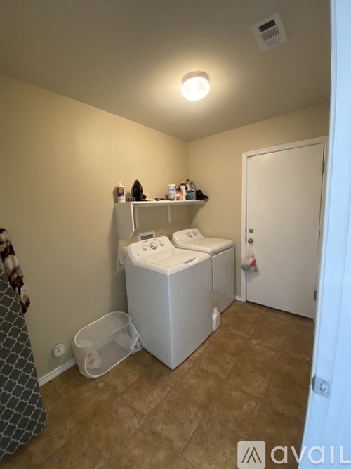 A small laundry room with a washer and dryer.
