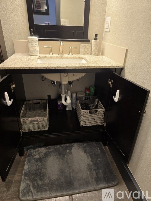 A bathroom with a sink and a mirror.